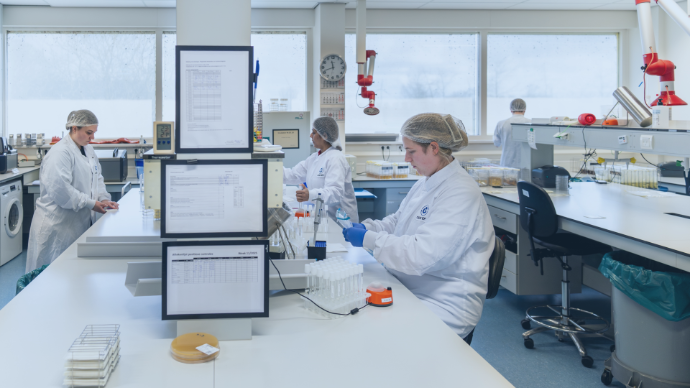 Scientists conducting infant formula and FSMP testing in ISO 17025-accredited laboratory at CCIC Europe Food Test.